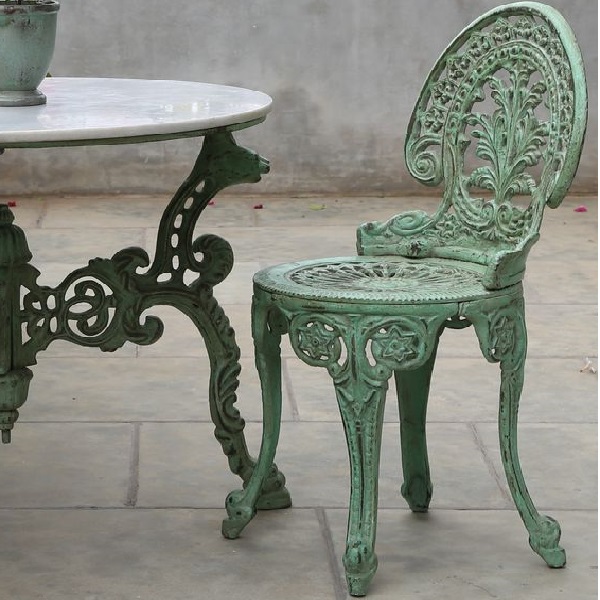 cast iron chairs and tables in a garden